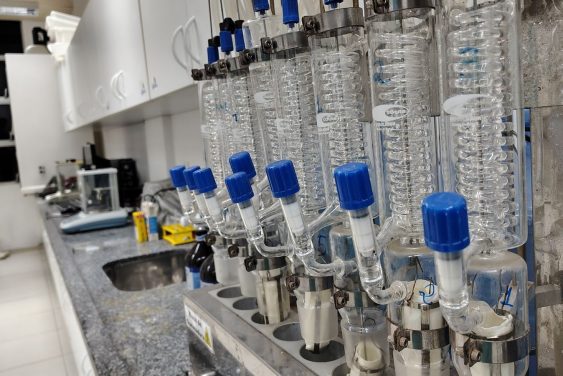 Image of a laboratory setup with glass condensers and lab equipment on the countertop.