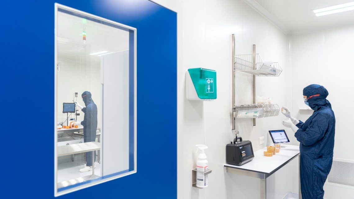 a person in a lab coat looking at a mirror