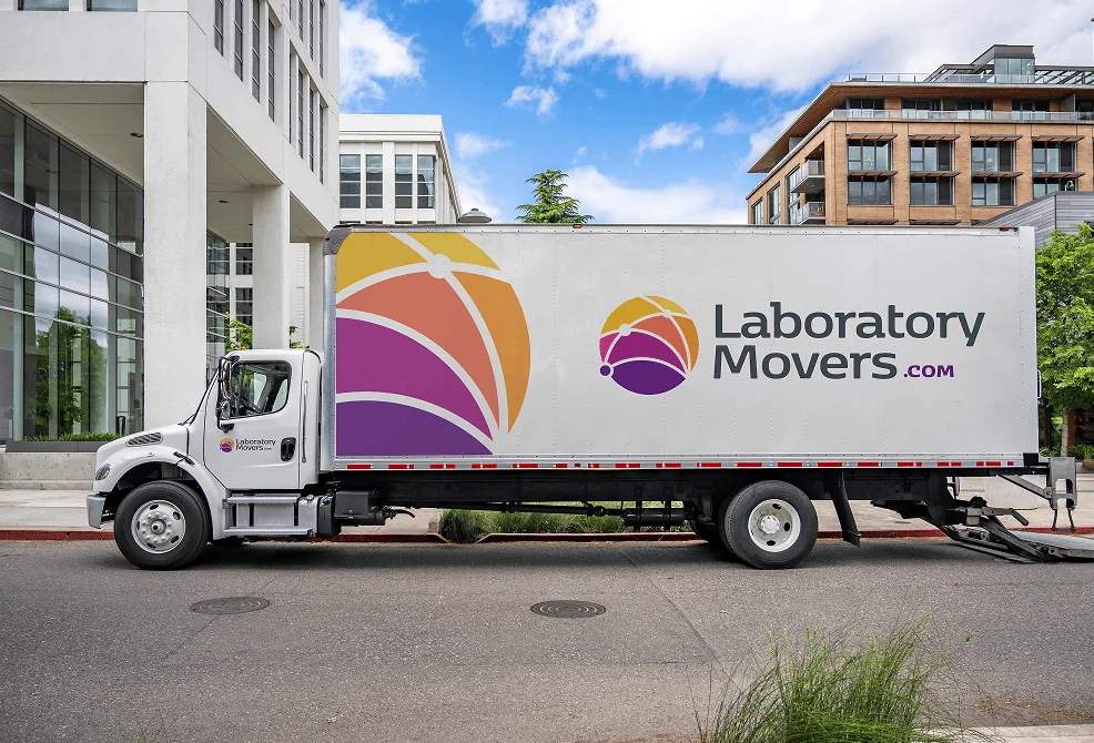 Laboratory Movers truck in front of buildings