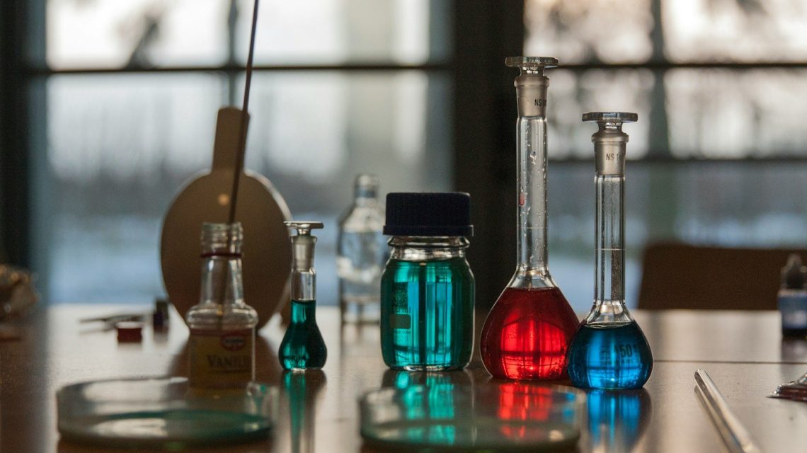 A table topped with flasks filled with liquid