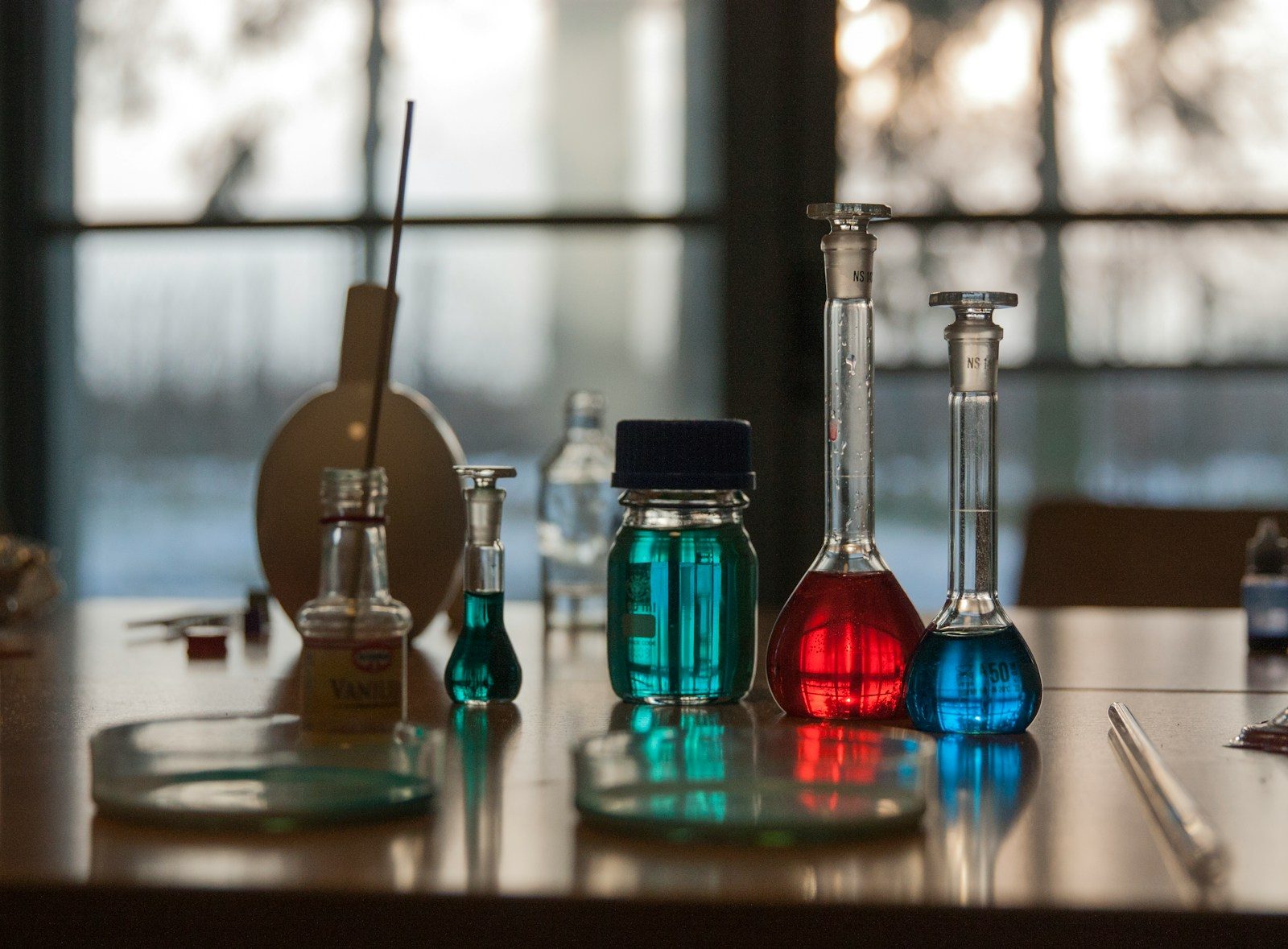 A table topped with flasks filled with liquid