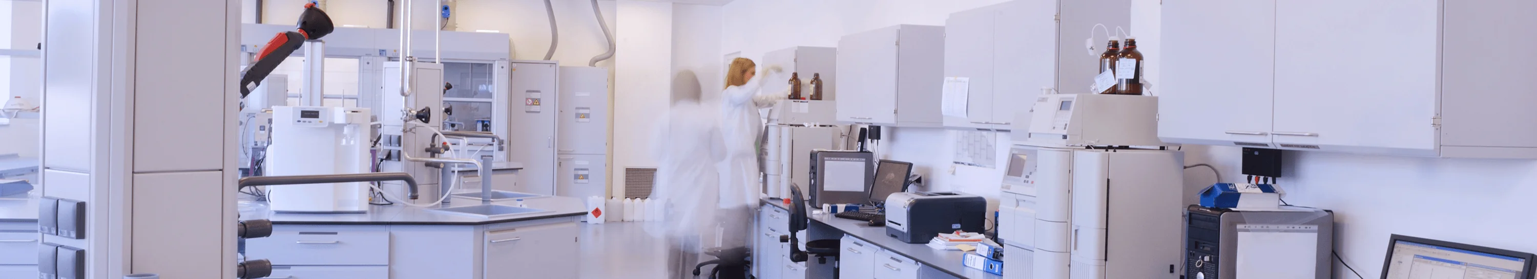 Timelapse image of two workers in a lab