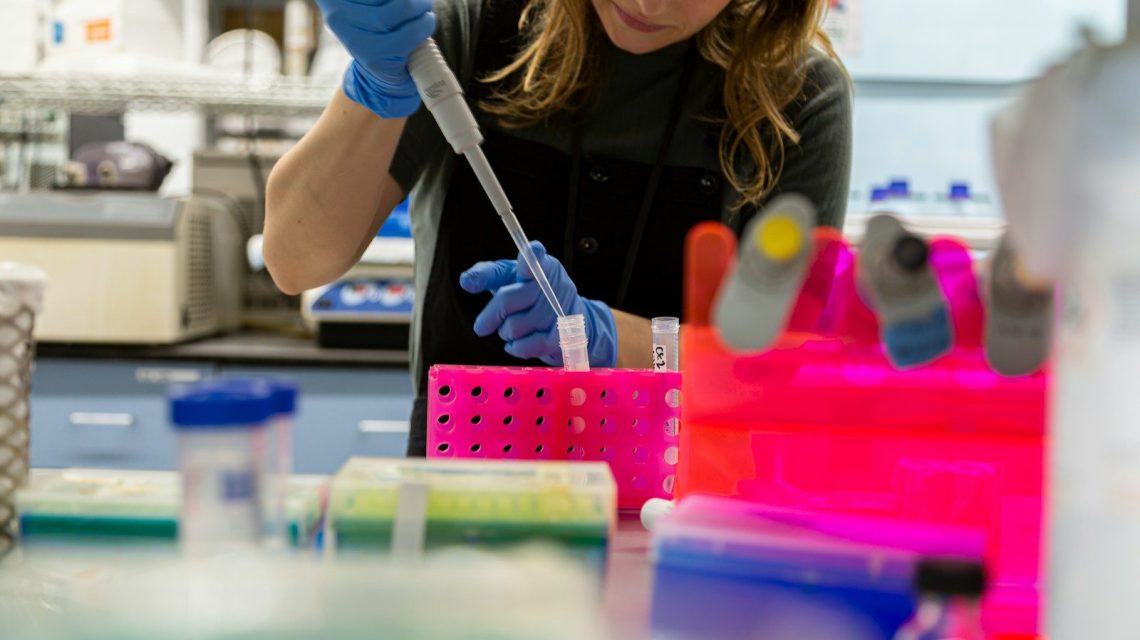 Scientist uses pipette in a laboratory