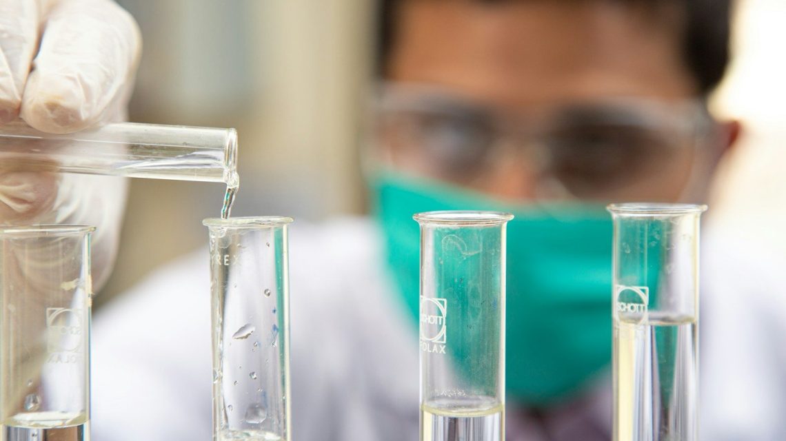 clear glass test tubes on blue plastic container